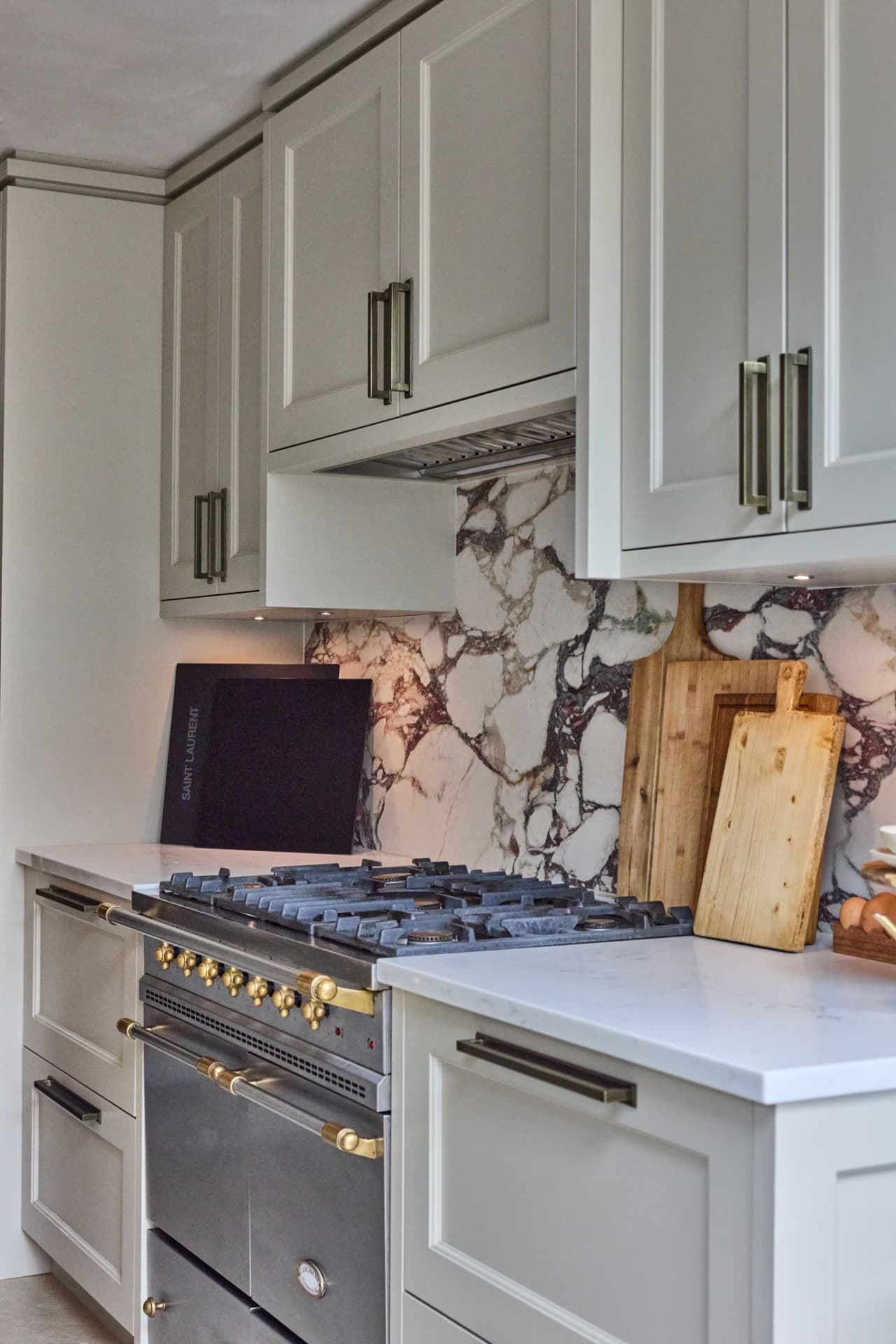 Kitchen with marble backsplash and shaker cabinetry at Cambridge Terrace