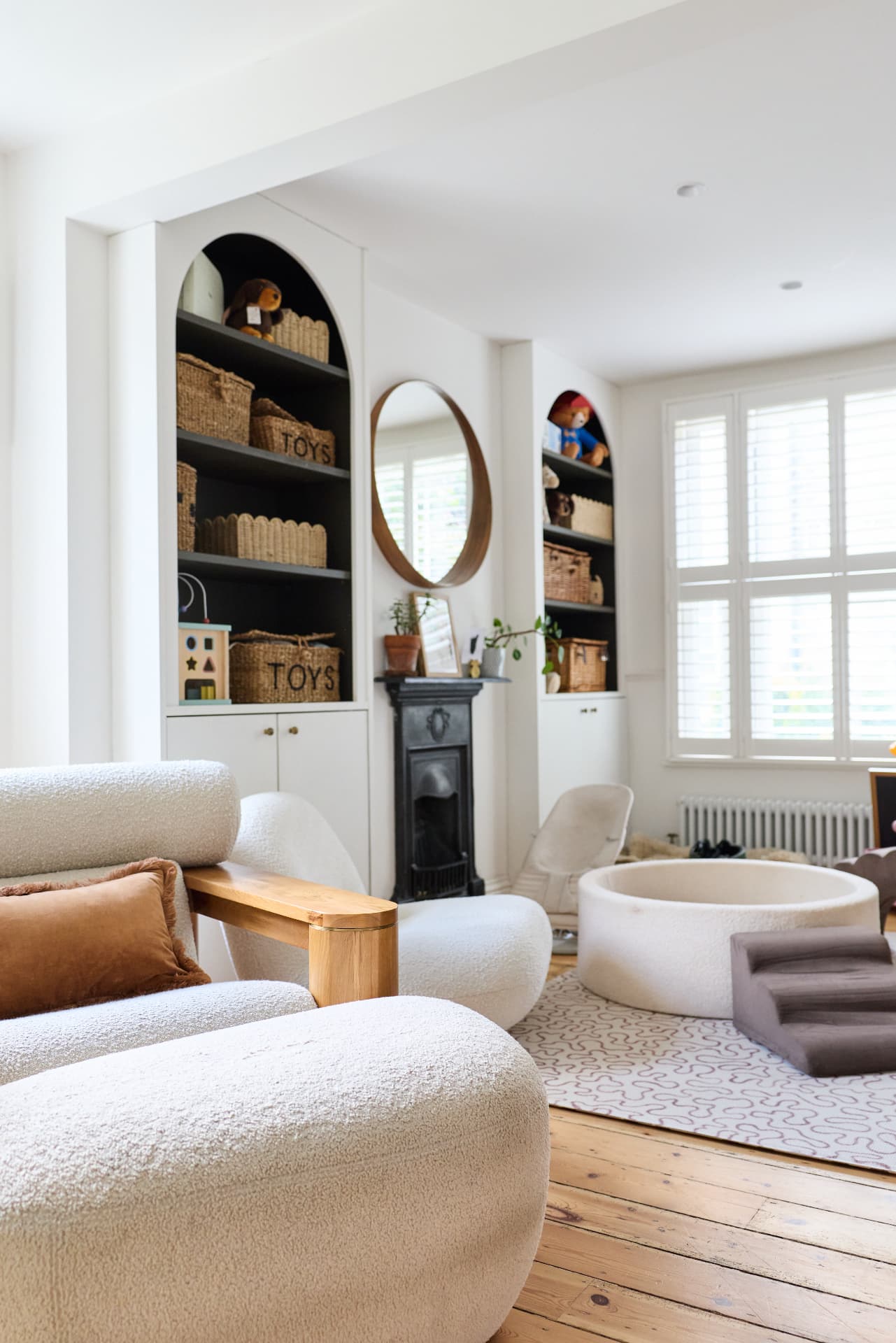 Living room with fireplace and built-in shelving at Cambridge Terrace