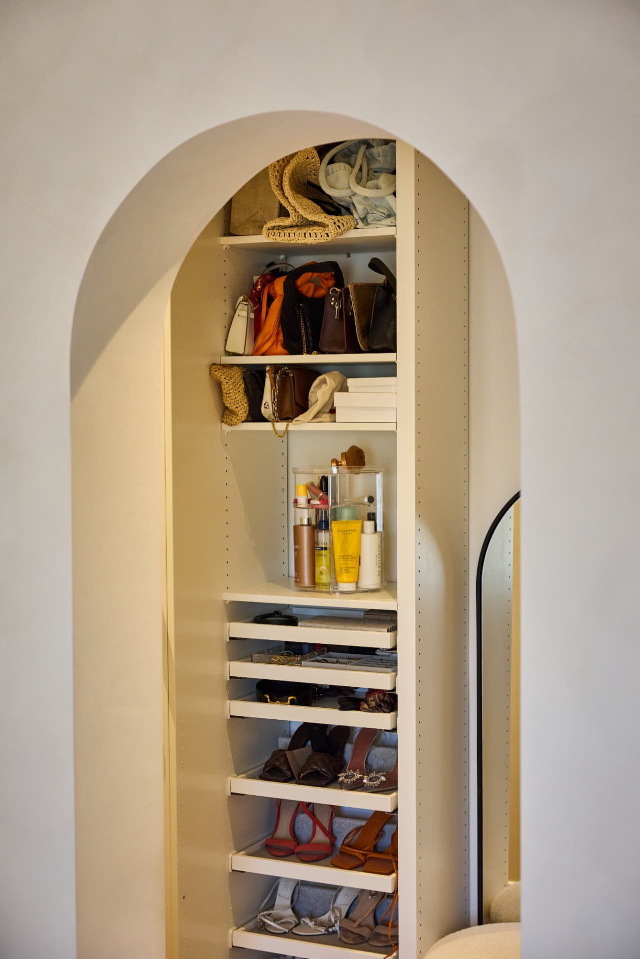 Walk-in closet through an arched opening at Cambridge Terrace